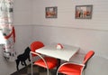 Little table and red chairs in modern cafe Royalty Free Stock Photo