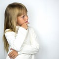 Little tanned girl in white badlon on a gray background.