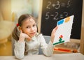 Little teacher. Beautiful young girl is teaching at home on blac