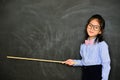 Little teacher using stick pointing chalkboard