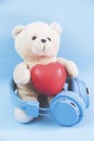 Little teddy bear , a valentine`s gift for lover isolated on light blue background Royalty Free Stock Photo