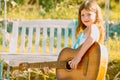 Little teen girl musician playing guitar. Dreamy kids face. Smiling child playing outdoors in summer. Royalty Free Stock Photo