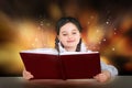 Little teen girl reads magical fairy tutorial book smiling