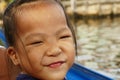 Portrait of a cute little girl in a boat along a river in Bangkok