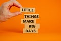 Little things make big days symbol. Wooden blocks with words Little things make big days. Businessman hand. Beautiful orange