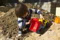 Little boy playing with toy digger and dumper truck. Royalty Free Stock Photo