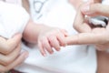 Little tiny baby hand holding mother finger Royalty Free Stock Photo