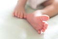 Little tiny feet and toes of happy newborn baby sleeping in the baby bed in the morning sunlight. family and healthy baby concept Royalty Free Stock Photo