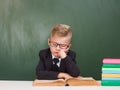 Little tired and sleepy boy sits in classroom Royalty Free Stock Photo