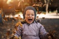 Little toddler boy in autumn park with leaves falling. Emotions of happiness and joy Royalty Free Stock Photo