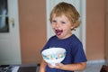 Little toddler boy with dirty face eating fresh blueberry Royalty Free Stock Photo