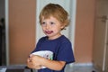 Little toddler boy with dirty face eating fresh blueberry Royalty Free Stock Photo