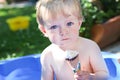 Little toddler boy eating ice cream in cone Royalty Free Stock Photo