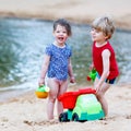 Little toddler boy and girl playing together with sand toys Royalty Free Stock Photo