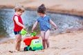 Little toddler boy and girl playing together with sand toys near Royalty Free Stock Photo