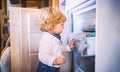 Toddler boy in dangerous situation at home. Child safety concept. Royalty Free Stock Photo