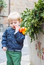 Little toddler boy outdoors and decorated with Easter eggs water