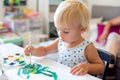 Little toddler boy, painting at home, learning coordination of moves Royalty Free Stock Photo