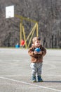 Little toddler boy, playing with ball on playground Royalty Free Stock Photo