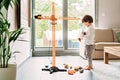 Little toddler boy playing with big construction building crane toy at home Royalty Free Stock Photo
