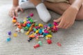 Little toddler boy playing with colorful plastic toys at home creative game, imagination