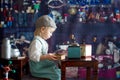 Little toddler boy, playing with mill at home, sitting on vintage table Royalty Free Stock Photo