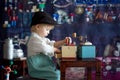 Little toddler boy, playing with mill at home, sitting on vintage table Royalty Free Stock Photo