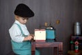 Little toddler boy, playing with mill at home, sitting on vintage table Royalty Free Stock Photo