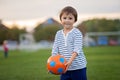 Little toddler boy playing soccer and football, having fun outdo Royalty Free Stock Photo