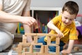 Little toddler boy playing wooden blocks with dad. Spending time with children. Educational activities for kids Royalty Free Stock Photo
