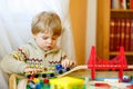Little toddler boy playing with wooden railway, indoors Royalty Free Stock Photo