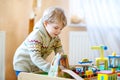 Little toddler boy playing with wooden railway, indoors Royalty Free Stock Photo