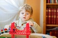 Little toddler boy playing with wooden railway, indoors Royalty Free Stock Photo