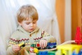 Little toddler boy playing with wooden railway, indoors Royalty Free Stock Photo