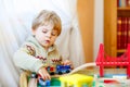 Little toddler boy playing with wooden railway, indoors Royalty Free Stock Photo