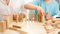 Little toddler boy putting wooden blocks or domino in long line. Concept of children education at home during lockdown Royalty Free Stock Photo