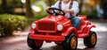 Little toddler boy rides a toy car in an amusement park. Child drives electric powered toy car in a city park. Generative AI