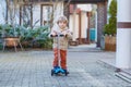 Little toddler boy riding and his scooter bicycle in summer Royalty Free Stock Photo