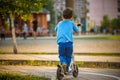 Little toddler boy riding and his scooter Royalty Free Stock Photo