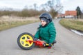 Little toddler boy sad about his broken bicycle