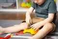 A little toddler boy 2,5 years is playing with a toy helicopter, assembling and disassembling it. Royalty Free Stock Photo