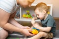 A little toddler boy 2,5 years is playing with a toy helicopter, assembling and disassembling it with father. Royalty Free Stock Photo