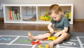 A little toddler boy 2,5 years is playing with a toy helicopter, assembling and disassembling it. Royalty Free Stock Photo