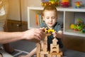 Little toddler boy 2,5 years playing wooden blocks and toy cars with dad. Spending time with children Royalty Free Stock Photo