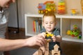 Little toddler boy 2.5 years playing wooden blocks and toy cars with dad. Spending time with children. Educational activities for Royalty Free Stock Photo