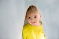 Little toddler boy with yellow shirt, hiding under blanket, smiling Royalty Free Stock Photo