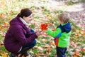 Little toddler boy and young mother in the autumn park Royalty Free Stock Photo
