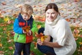 Little toddler boy and young mother in the autumn park Royalty Free Stock Photo