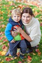 Little toddler boy and young mother in the autumn park Royalty Free Stock Photo