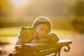 Little toddler child, boy, playing with airplane and knitted teddy bear in autumn park Royalty Free Stock Photo